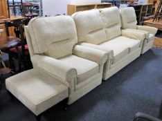A contemporary three piece lounge suite in beige floral fabric plus footstool