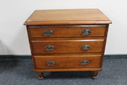 An antique pine three drawer chest