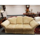 A three seater settee upholstered in gold classical brocade fabric