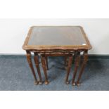 A nest of three stained beech tables