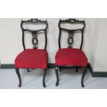 A pair of Victorian ebonised dining chairs on cabriole legs