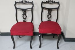 A pair of Victorian ebonised dining chairs on cabriole legs