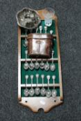 A set of eighteen EPNS teaspoons on wall rack, leather cased vintage field glasses, plated dish,