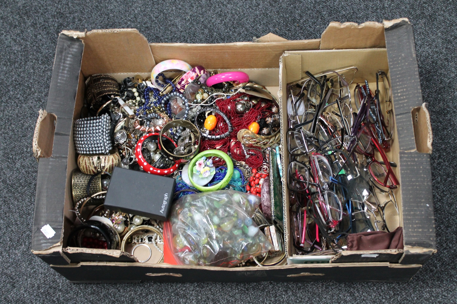 A box of a bag of marbles, assorted costume jewellery, watches,