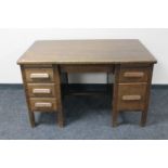 A 1930's oak twin pedestal desk