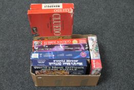 A box of vintage Monopoly & Cluedo games and five assorted jigsaws