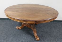 A Victorian oval tilt top pedestal table