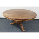 A Victorian oval tilt top pedestal table