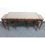 A mahogany glass topped coffee table fitted two tables beneath