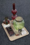 A tray of two early 20th century oil lamps, vintage green glass storage jar with lid,