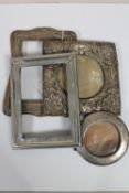 Four antique silver photograph frames.