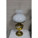 An antique brass Aladdin oil lamp with glass shade and chimney