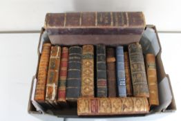 A box of thirteen antique leather bound volumes