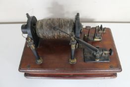 A late 19th century ebony electric current instrument mounted on a mahogany board