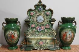 A late nineteenth century china mantel clock and pair of transfer printed vases