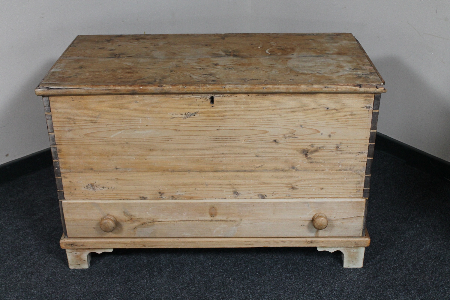 An antique pine blanket chest fitted a drawer