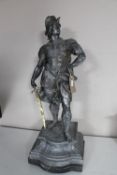 An antique bronzed statue of a classical warrior,