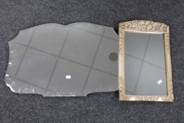 A shaped 1930's unframed mirror and a silvered framed mirror