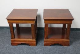 A pair of contemporary lamp tables in a mahogany finish