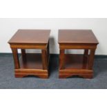 A pair of contemporary lamp tables in a mahogany finish