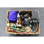 A box of clock radio, camera, goblets, clock under shade,