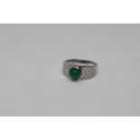 An 18ct white gold cabochon emerald and diamond ring, 6.