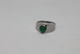 An 18ct white gold cabochon emerald and diamond ring, 6.