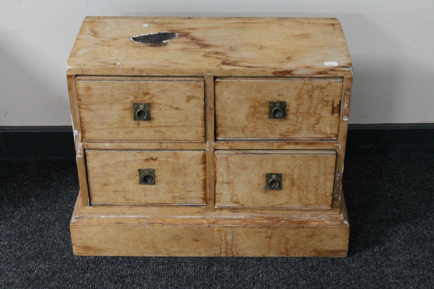An antique pine miniature four drawer chest