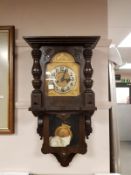 A continental oak cased wall clock with pendulum