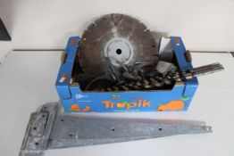 A box of industrial drill bits, diamond cutting blade,