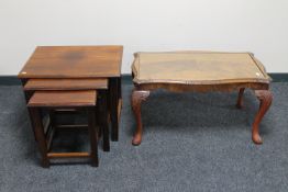 A nest of three mahogany occasional tables and a glass topped coffee table