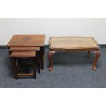 A nest of three mahogany occasional tables and a glass topped coffee table