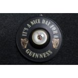 A circular Short & Mason barometer mounted on board bearing Guinness advertising