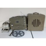 A vintage 16mm projector with power packs and speaker
