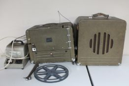 A vintage 16mm projector with power packs and speaker