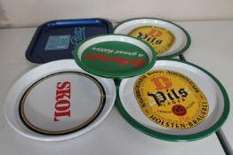 Ten vintage beer trays bearing advertising