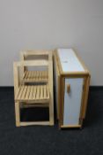 A contemporary drop leaf kitchen table and four chairs