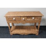 An antique pine two drawer side table in scumbled finish