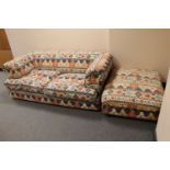 A contemporary two seater cloth settee in Aztec print and an oversized footstool