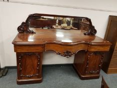 A Victorian mahogany mirror backed serpentine fronted twin pedestal sideboard, width 197 cm.