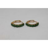 A pair of high carat gold mounted jade hoop earrings