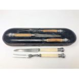 A three piece boxed Victorian carving set with bone handles and ornate silver mounts,