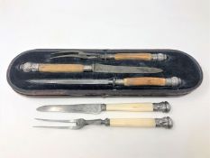 A three piece boxed Victorian carving set with bone handles and ornate silver mounts,