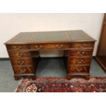 A reproduction mahogany double pedestal desk retailed by Chapmans,