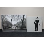 A large framed Ikea print of Amsterdam and a framed canvas of Charlie Chaplin