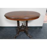 A Victorian walnut oval pedestal occasional table