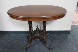 A Victorian walnut oval pedestal occasional table