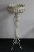 A painted wrought metal jardiniere stand