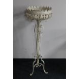 A painted wrought metal jardiniere stand
