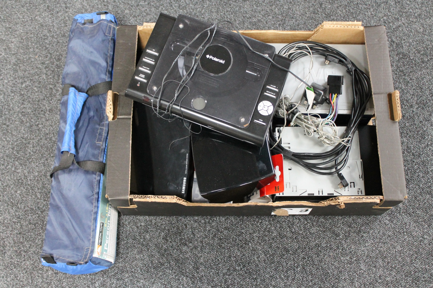 A box of assorted electricals : car radio, Samsung speakers,